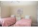 Inviting bedroom featuring two twin beds, a central nightstand, and soft lighting, ideal for guests or children at 426 Bouchelle Dr # 401, New Smyrna Beach, FL 32169