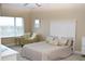 Bright bedroom featuring neutral tones, plush chair, and a comfortable bed with decorative pillows at 426 Bouchelle Dr # 401, New Smyrna Beach, FL 32169