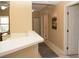 Neutral hallway features a white door, tile floors, and a decorative art piece at 426 Bouchelle Dr # 401, New Smyrna Beach, FL 32169