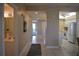 Bright hallway with tile flooring, connecting living spaces, bathroom, and kitchen at 426 Bouchelle Dr # 401, New Smyrna Beach, FL 32169
