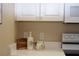 Kitchen counter with white cabinetry, stainless steel appliances, and neutral decor at 426 Bouchelle Dr # 401, New Smyrna Beach, FL 32169
