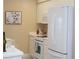 Bright kitchen with white cabinets, countertops, and modern appliances at 426 Bouchelle Dr # 401, New Smyrna Beach, FL 32169