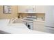 Bright kitchen with white appliances, cabinets, countertops, and stainless steel appliances at 426 Bouchelle Dr # 401, New Smyrna Beach, FL 32169