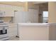 Well-lit kitchen with white appliances, cabinetry, and countertops at 426 Bouchelle Dr # 401, New Smyrna Beach, FL 32169