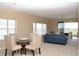 Combined dining and living spaces with a seamless flow, comfortable seating, and natural light at 426 Bouchelle Dr # 401, New Smyrna Beach, FL 32169