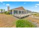 Home's backyard has a spacious deck and partial enclosure, offering a relaxing space to enjoy the coastal breeze at 4323 S Atlantic Ave, Port Orange, FL 32127