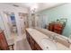 Elegant bathroom with double sinks, granite countertop, and walk-in shower at 4323 S Atlantic Ave, Port Orange, FL 32127
