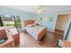 Bright bedroom with light blue walls, wood floors, and a view of the outside at 4323 S Atlantic Ave, Port Orange, FL 32127