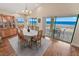 Elegant dining room with a large window, wood floors, and a view of the beach at 4323 S Atlantic Ave, Port Orange, FL 32127