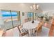 Dining area with wood floors and lots of natural light, featuring beautiful ocean views through sliding glass doors at 4323 S Atlantic Ave, Port Orange, FL 32127