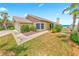 Charming single-story home featuring a manicured lawn and palm tree landscaping at 4323 S Atlantic Ave, Port Orange, FL 32127