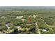 Aerial view of a beautiful wooded property with waterfront access at 4580 Lake James Cir, Edgewater, FL 32141