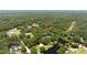 Expansive aerial view shows this beautiful home surrounded by lush mature trees and water at 4580 Lake James Cir, Edgewater, FL 32141