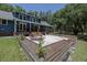 Large backyard with a gravel patio, raised garden beds, and a well-maintained lawn at 4580 Lake James Cir, Edgewater, FL 32141