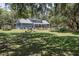Expansive backyard with lush green grass and mature trees, offering privacy and space for outdoor activities at 4580 Lake James Cir, Edgewater, FL 32141