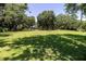 Spacious backyard with lush green grass and mature trees at 4580 Lake James Cir, Edgewater, FL 32141