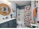 Bathroom featuring a vanity with a round mirror and a bathtub with a shower at 4580 Lake James Cir, Edgewater, FL 32141