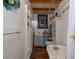 Cozy bathroom featuring white shiplap walls, wood-look floors, and a built-in bathtub at 4580 Lake James Cir, Edgewater, FL 32141