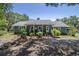 Charming single-story home featuring a cozy front porch and beautifully landscaped front yard at 4580 Lake James Cir, Edgewater, FL 32141