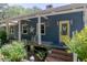 Inviting front porch with rocking chairs and a bright yellow door, perfect for relaxing outdoors at 4580 Lake James Cir, Edgewater, FL 32141