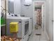 Bright laundry room with side-by-side washer and dryer and an adjacent bathroom at 4580 Lake James Cir, Edgewater, FL 32141