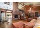 Cozy living room with a brick fireplace and high ceilings, blending rustic charm with modern comfort at 4580 Lake James Cir, Edgewater, FL 32141