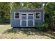 Charming shed with double doors and windows, perfect for storage or hobbies at 4580 Lake James Cir, Edgewater, FL 32141