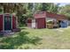 Multiple storage sheds and outbuildings on a well-kept lawn at 4580 Lake James Cir, Edgewater, FL 32141