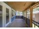 Inviting screened-in porch with wood flooring and views of the yard at 4580 Lake James Cir, Edgewater, FL 32141