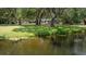 Scenic view of the waterfront property from the water's edge at 4580 Lake James Cir, Edgewater, FL 32141