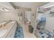 Bathroom featuring dual sinks, a tub, separate toilet, and a walk-in closet at 4670 Links Village Dr # D206, Ponce Inlet, FL 32127