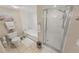 Bright bathroom with white fixtures, tub, and glass enclosed shower at 4670 Links Village Dr # D206, Ponce Inlet, FL 32127