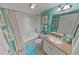 Bathroom featuring a shower-tub combo, vanity sink, and blue accents at 4670 Links Village Dr # D206, Ponce Inlet, FL 32127