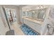 Bright bathroom with dual sinks and views into ensuite shower and bedroom at 4670 Links Village Dr # D206, Ponce Inlet, FL 32127