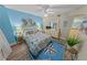 Bedroom with a bed, beach themed decor, and wood-look floors at 4670 Links Village Dr # D206, Ponce Inlet, FL 32127