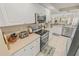Gourmet kitchen featuring stainless appliances, granite countertops, and ample cabinet storage at 4670 Links Village Dr # D206, Ponce Inlet, FL 32127