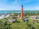 Aerial view of the historic Ponce Inlet Lighthouse, museum, and community at 4670 Links Village Dr # D206, Ponce Inlet, FL 32127