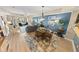 The living room features coastal decor, wood floors, and sliding glass doors to the balcony at 4670 Links Village Dr # D206, Ponce Inlet, FL 32127
