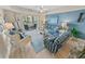 Bright living room boasts modern coastal decor, furnishings and access to a balcony at 4670 Links Village Dr # D206, Ponce Inlet, FL 32127