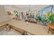 Open-concept living space with dining area, living room, and access to the balcony at 4670 Links Village Dr # D206, Ponce Inlet, FL 32127