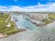 Scenic view of a marina with numerous boats docked alongside condo buildings on a sunny day at 4670 Links Village Dr # D206, Ponce Inlet, FL 32127