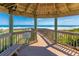 Breathtaking ocean view from a wooden gazebo, showcasing the beautiful beach and coastline in a tropical paradise at 4670 Links Village Dr # D206, Ponce Inlet, FL 32127