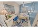 Cozy office space featuring stylish decor with an ocean painting, comfortable seating, and ample natural light at 4670 Links Village Dr # D206, Ponce Inlet, FL 32127