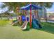 Colorful playground with slides and climbing structures on a green lawn, creating a fun and safe environment for children at 4670 Links Village Dr # D206, Ponce Inlet, FL 32127