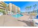 Exterior shot showcases a community pool area with ample lounge chairs, tables, and landscaping at 4670 Links Village Dr # D206, Ponce Inlet, FL 32127