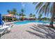 A view of a spacious pool area with a cabana and ample lounge seating by a condo complex at 4670 Links Village Dr # D206, Ponce Inlet, FL 32127
