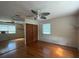 Bedroom featuring hardwood floors, fan, closet, and natural light, creating a serene atmosphere at 5018 Riverside Dr, Port Orange, FL 32127
