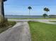 Driveway leading to water view and gazebo in the distance, showcasing the property's location at 5018 Riverside Dr, Port Orange, FL 32127