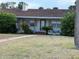 Charming single-story home featuring a classic red-tiled roof and cozy front yard with lush greenery at 5018 Riverside Dr, Port Orange, FL 32127