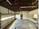 Spacious garage with exposed rafters and cinder block walls at 5018 Riverside Dr, Port Orange, FL 32127